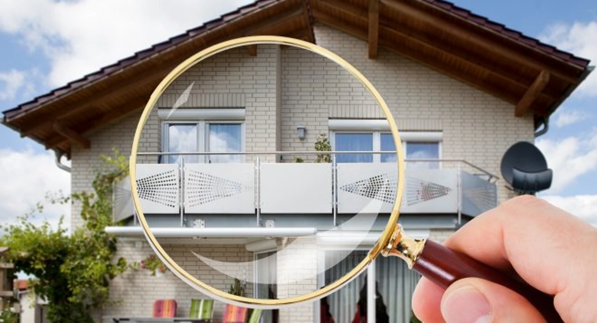 House with a magnifying glass enlarging it 