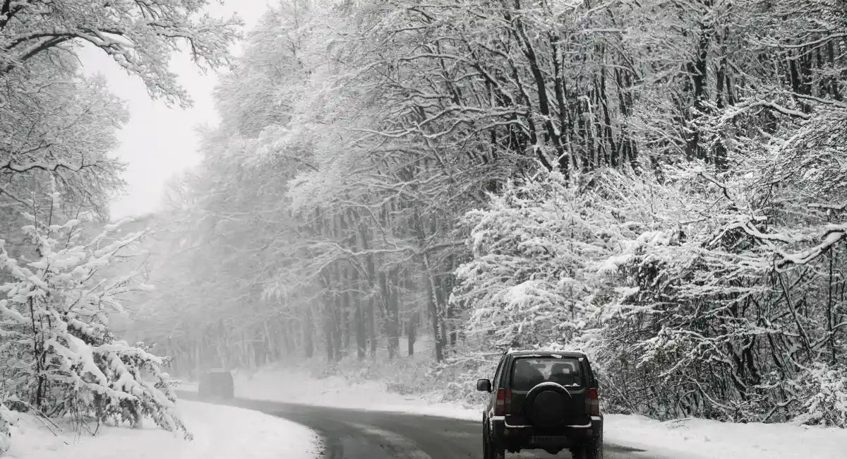 Car driving on snow covered road