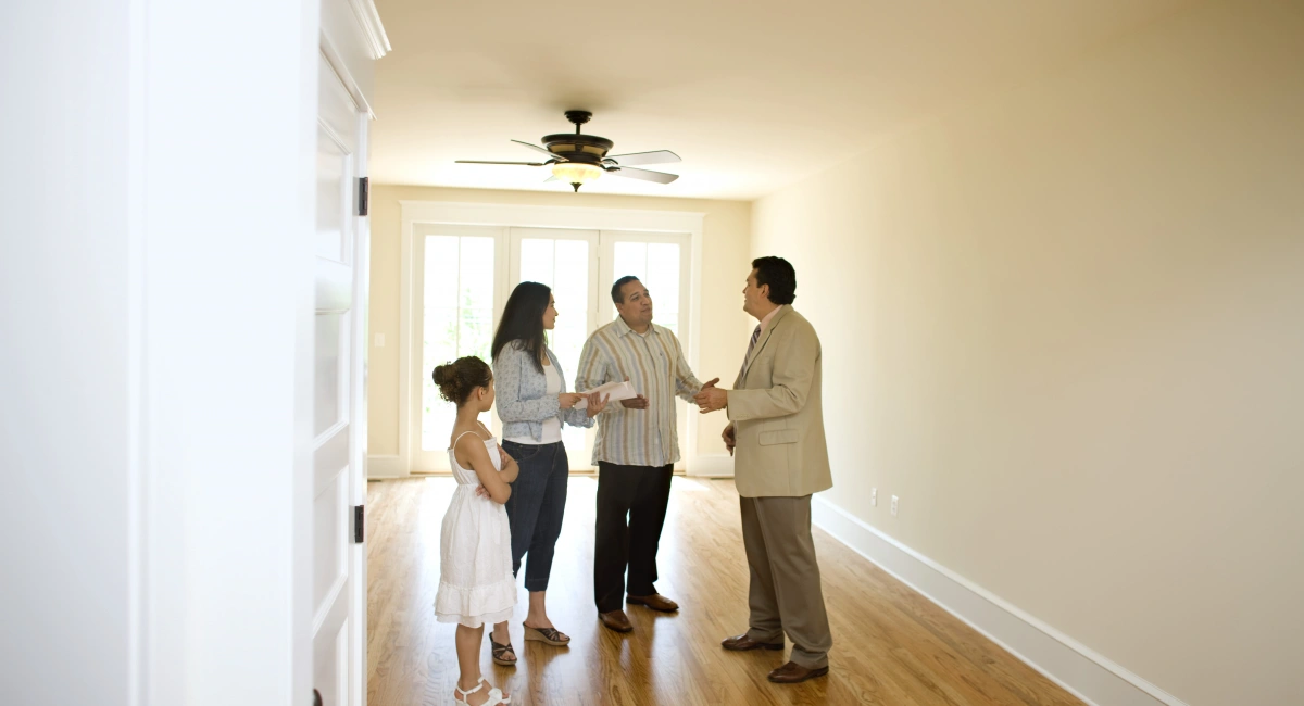 Family seeing their new home with estate agent