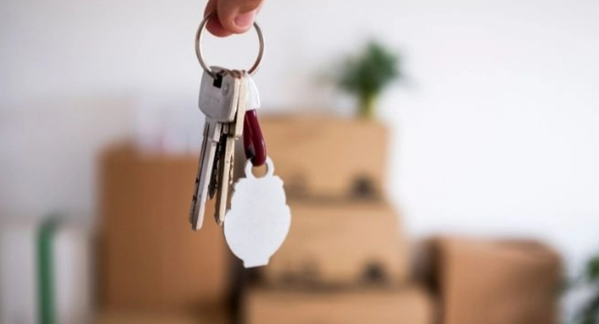 keys to a new house in front of sofa
