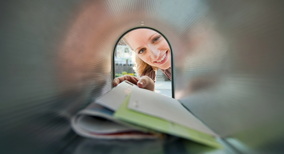 woman collecting post from mail box