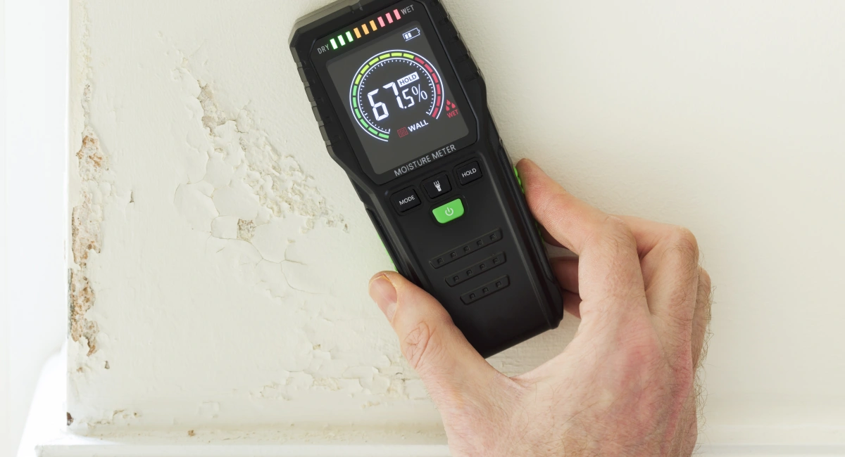 A moisture detection meter reading high moisture content