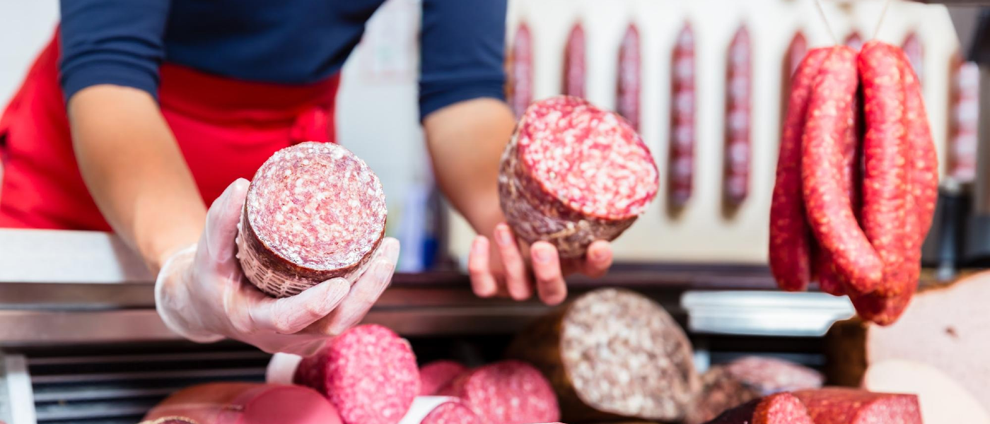 Image of butcher holding cured Christmas meats pest prevention