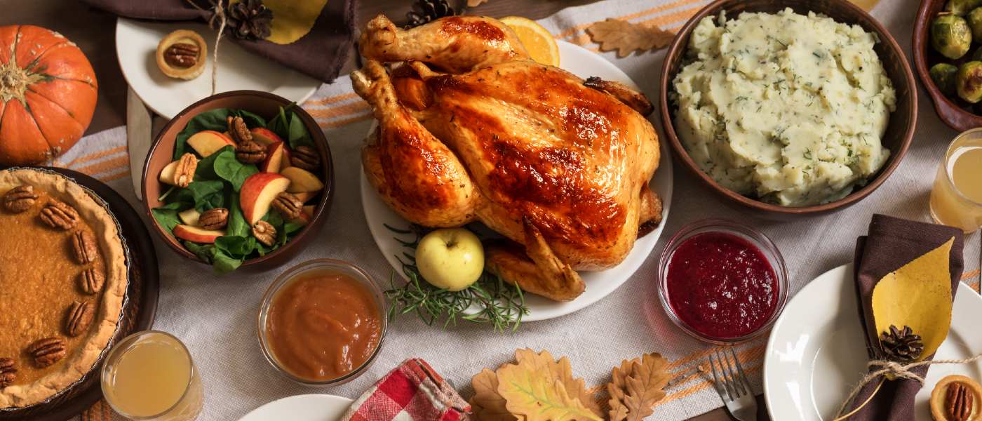 Dinner table arranged with a Thanksgiving feast