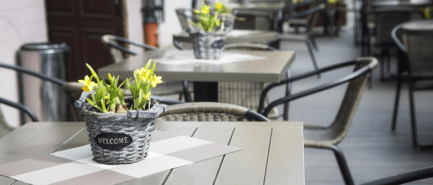 A restaurant patio outdoors, protected from pests.