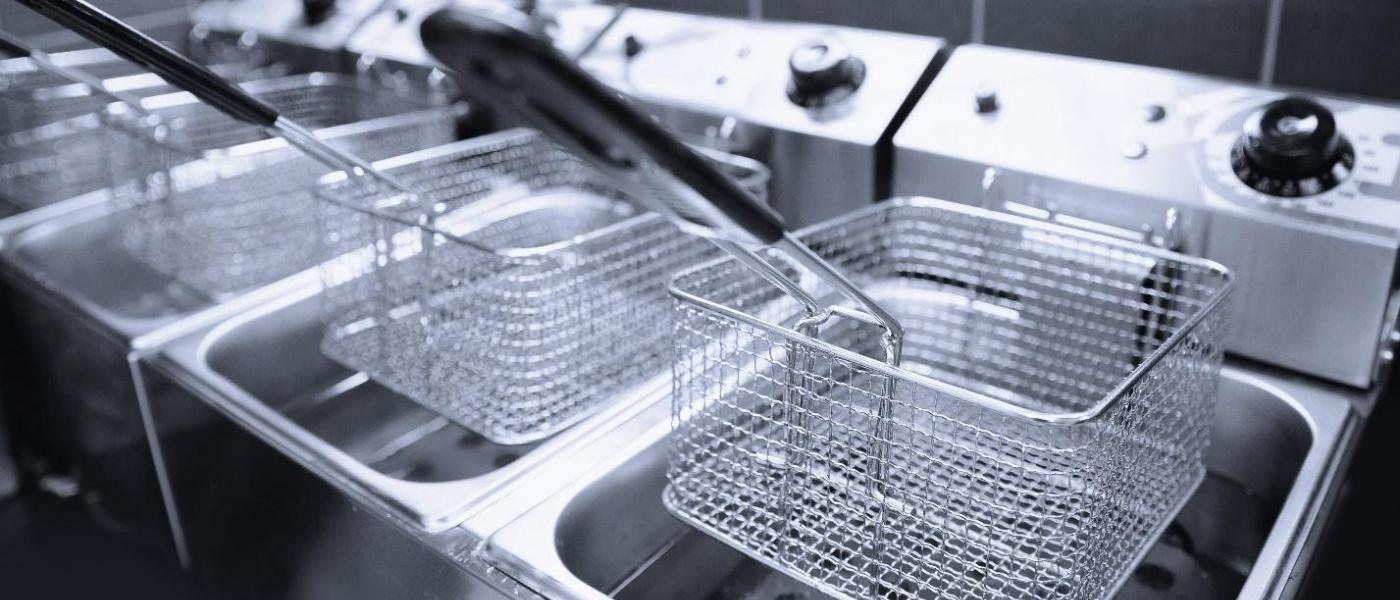 Clean deep frying machines inside a commercial kitchen