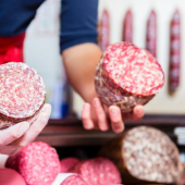 Image of butcher holding cured Christmas meats pest prevention