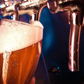 A bartender pouring a beer from the tap