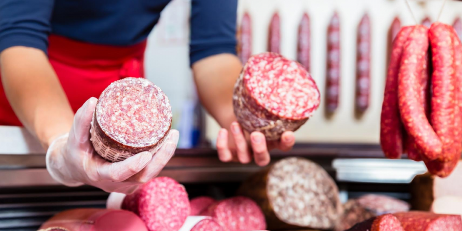 Image of butcher holding cured Christmas meats pest prevention