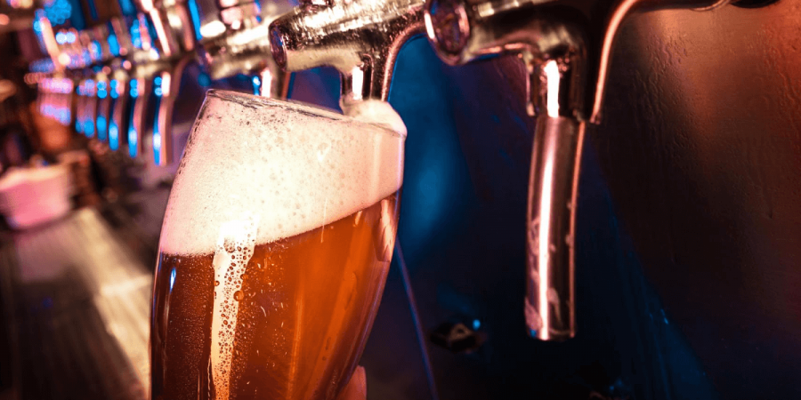 A bartender pouring a beer from the tap