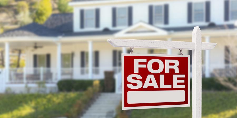 home with for sale sign in front