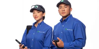 Two JP Pest professionals in uniform